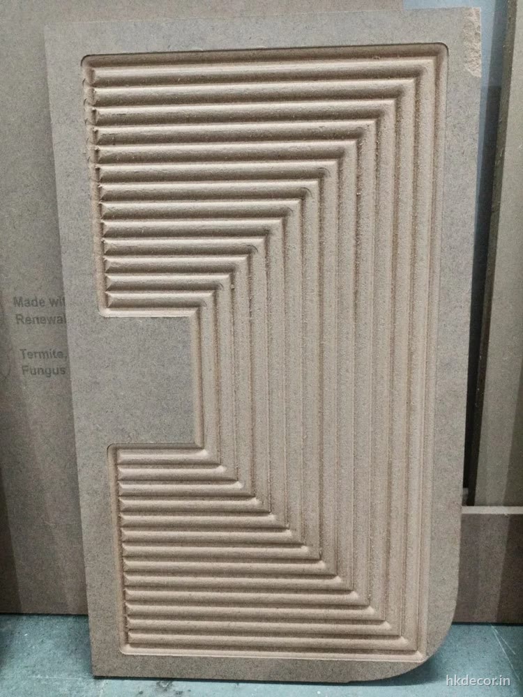 Stepped relief cut into raw MDF showing the clean pale edge a router leaves before any sanding