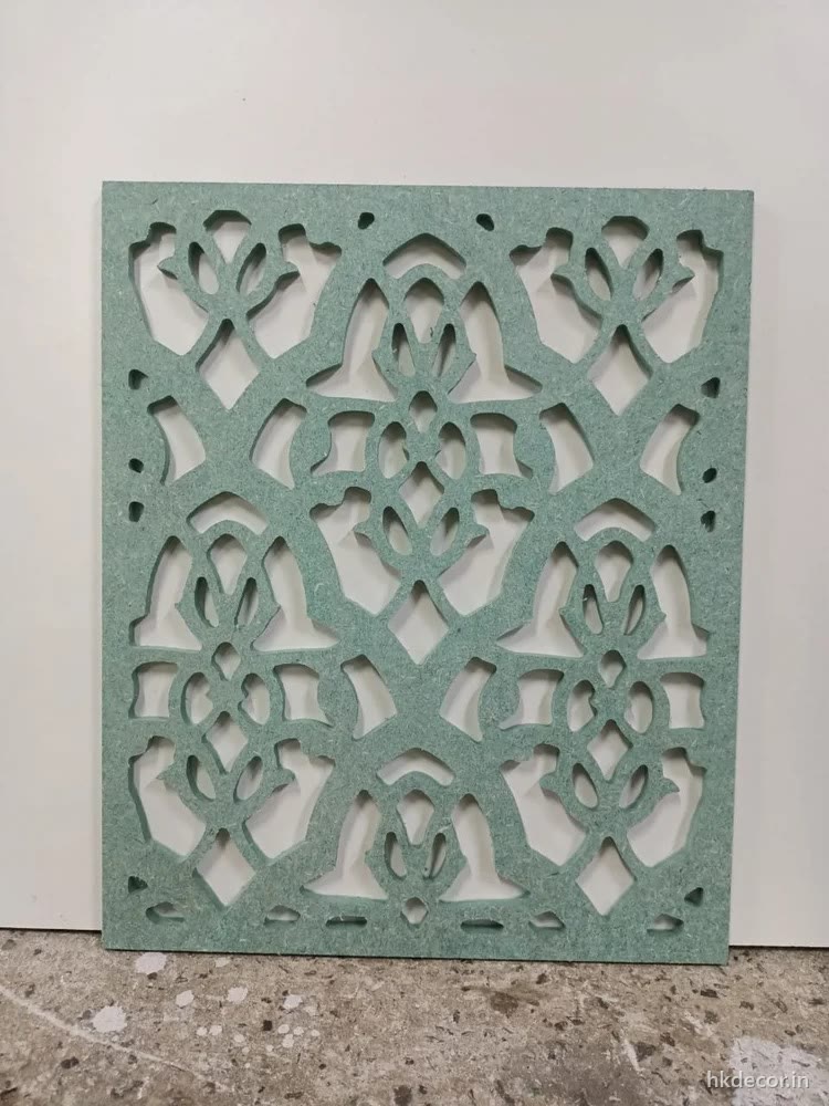 CNC cut MDF jaali panel with a scrolling perforated pattern, primed