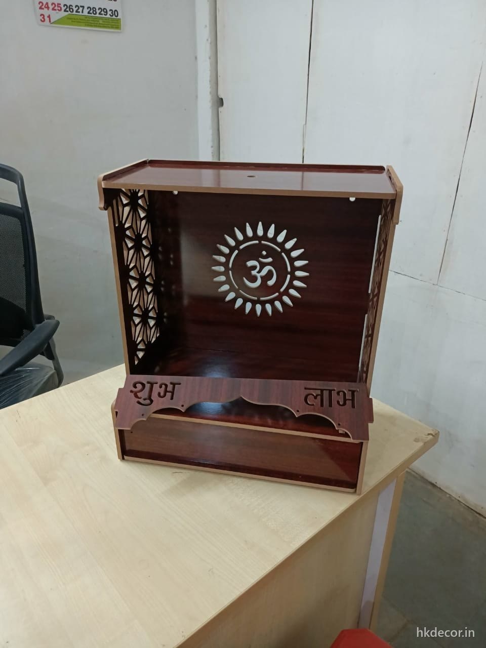 Laser cut home mandir in a dark wood finish with cut lettering and a radial backdrop